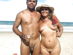 One arabian nudist man holding his great figure wife on the beach
