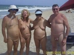 Group beach photo of two nudism loving families